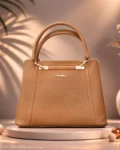 Tan brown structured handbag with double handles and gold hardware.