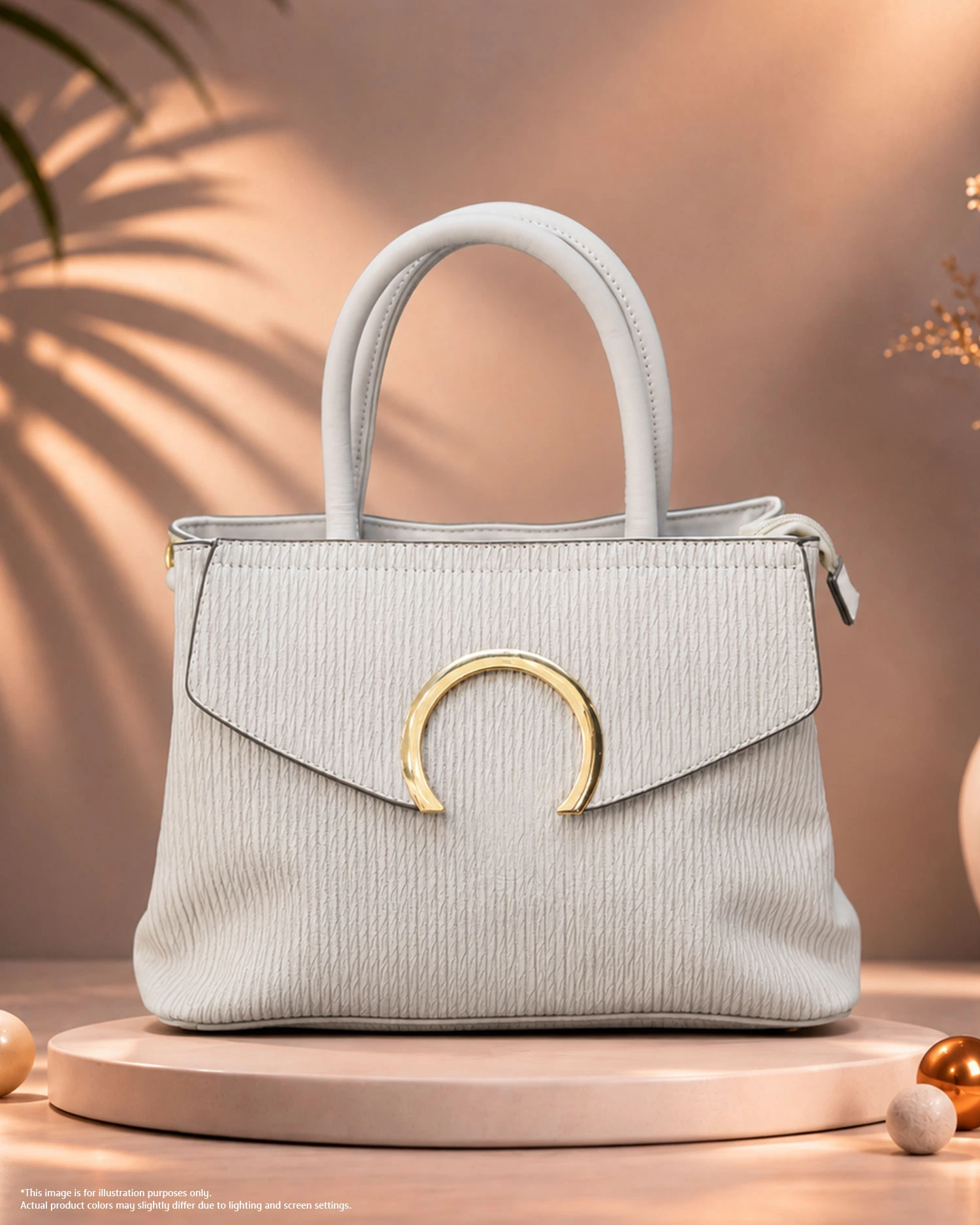 White Textured Handbag with Gold Detail White textured handbag with top handles and gold circular hardware.