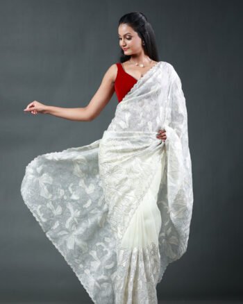 Off-white organza saree featuring intricate white floral thread embroidery and scalloped borders