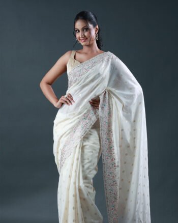Off-white soft brocade saree with subtle gold booti weave and pastel multicolor floral embroidered borders