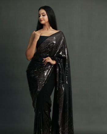 Black chiffon saree covered in all-over metallic black sequence work with a sleek fall