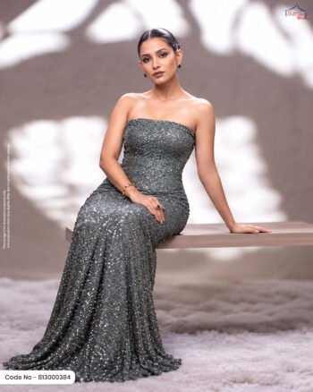 A woman wearing a glamorous dark silver embellished fabric styled as an elegant evening gown, showcasing its dense shimmering texture