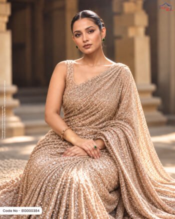 A woman wearing a luxurious champagne-gold embellished fabric styled as an elegant saree, showcasing its dense shimmering texture and intricate sparkling details