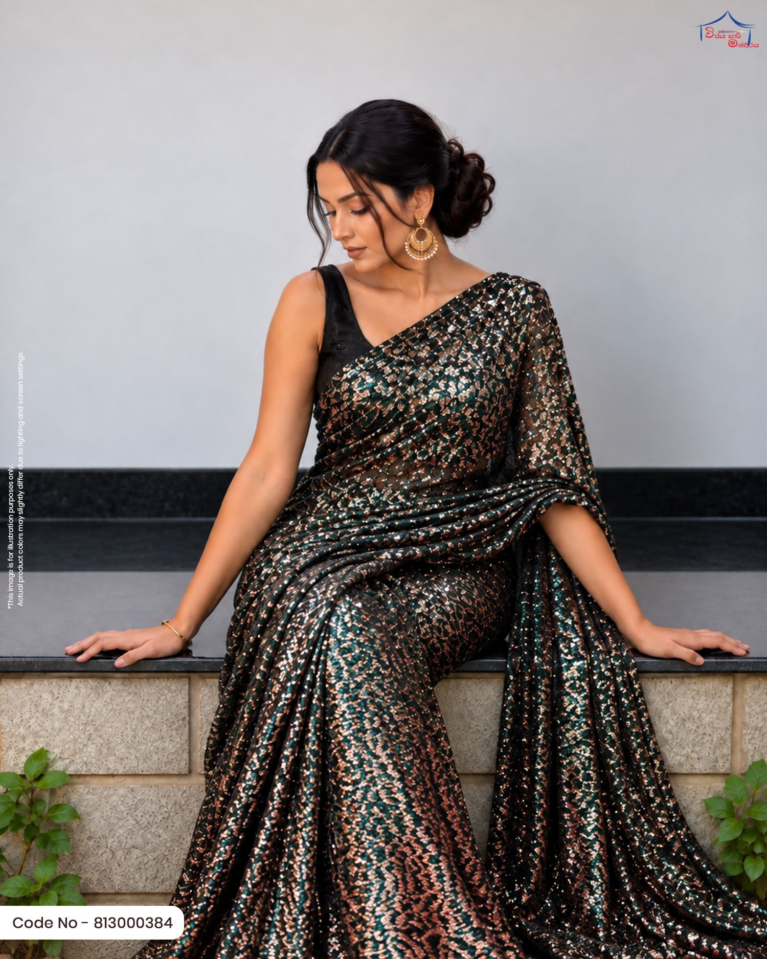 Emerald Green and Bronze Foil Printed Fabric A woman sitting on a ledge draped in an emerald green saree featuring dense copper/bronze foil work, paired with a black sleeveless blouse